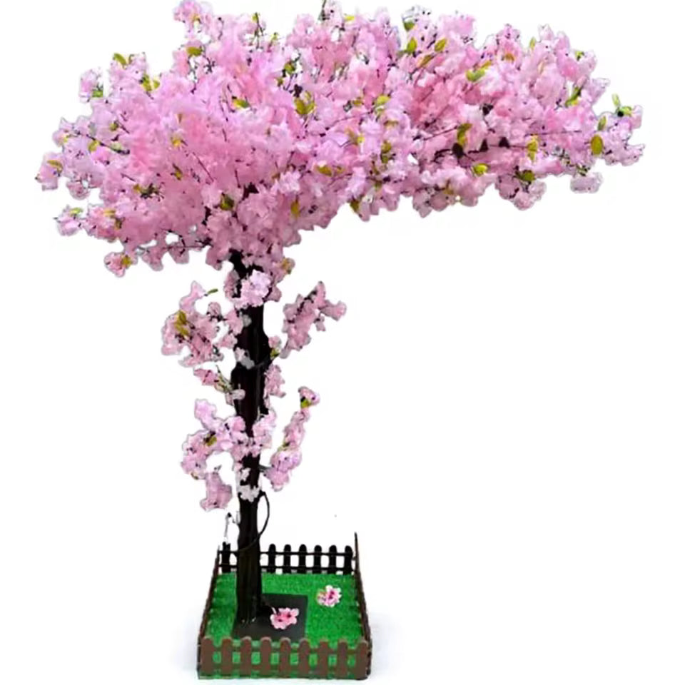 Artificial cherry blossom tree with champagne pink flowers and a realistic wood-textured trunk, shown in a decorative base with a small wooden fence.