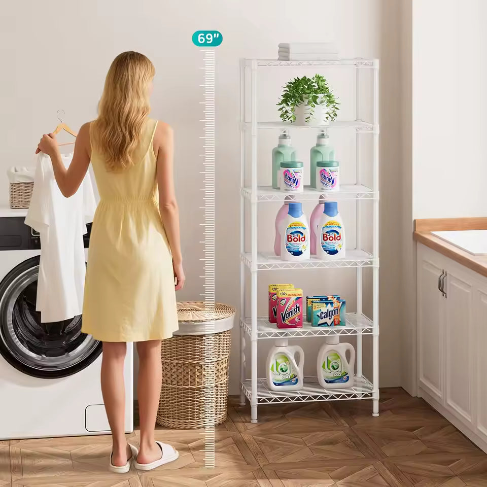 Tall white 6-tier adjustable metal wire shelving unit in a modern living room, holding books, plants, and decorative boxes.