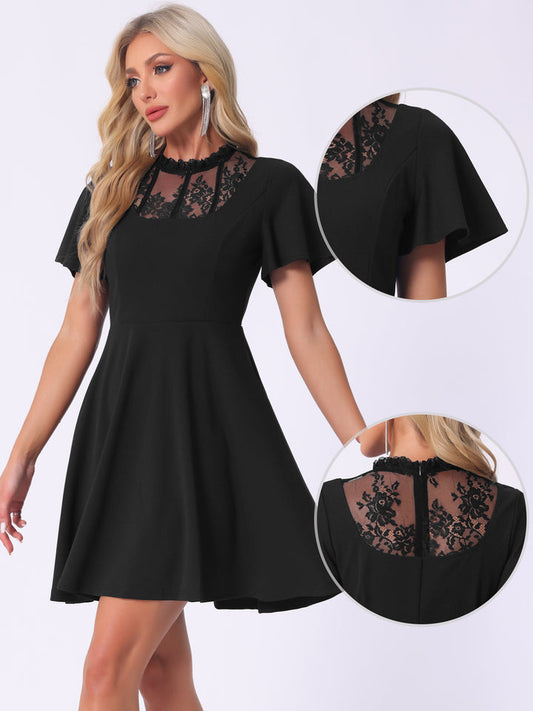 Black dress with lace details worn by a model on a white background