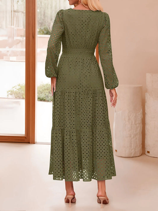 Woman wearing a green lace dress in an indoor setting