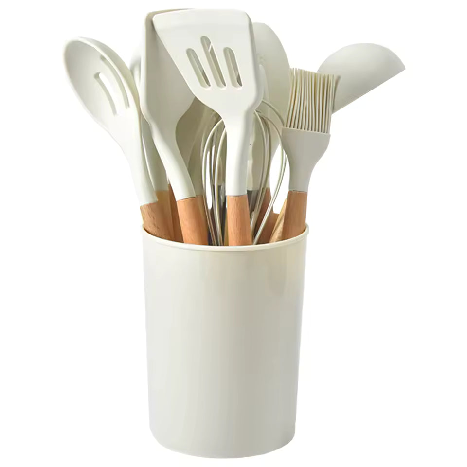 12-piece beige silicone kitchen utensil set with ergonomic oak wood handles in a matching cylindrical storage holder.