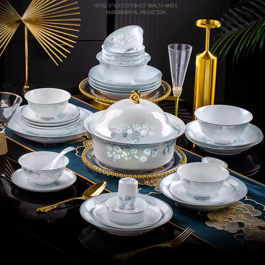 Luxurious 68-piece fine porcelain dinnerware set featuring underglaze floral patterns, large soup tureen, and banquet service plates on a formal dining table.