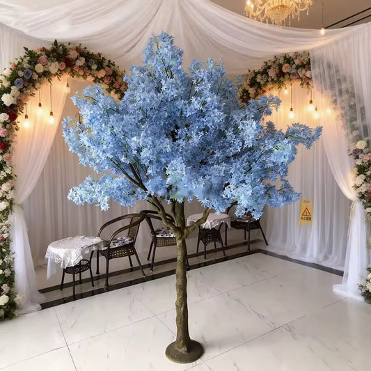 Mini blue artificial cherry blossom tree with silk flowers and fence for wedding table decoration and indoor event decor.