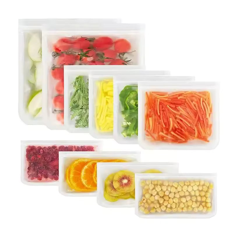 Set of various sized translucent reusable food storage bags filled with tomatoes, carrots, and nuts, showing a leakproof airtight seal.