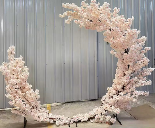 2.5-meter high pink artificial cherry blossom moon arch with welded frame and silk leaves for indoor wedding and event decoration.