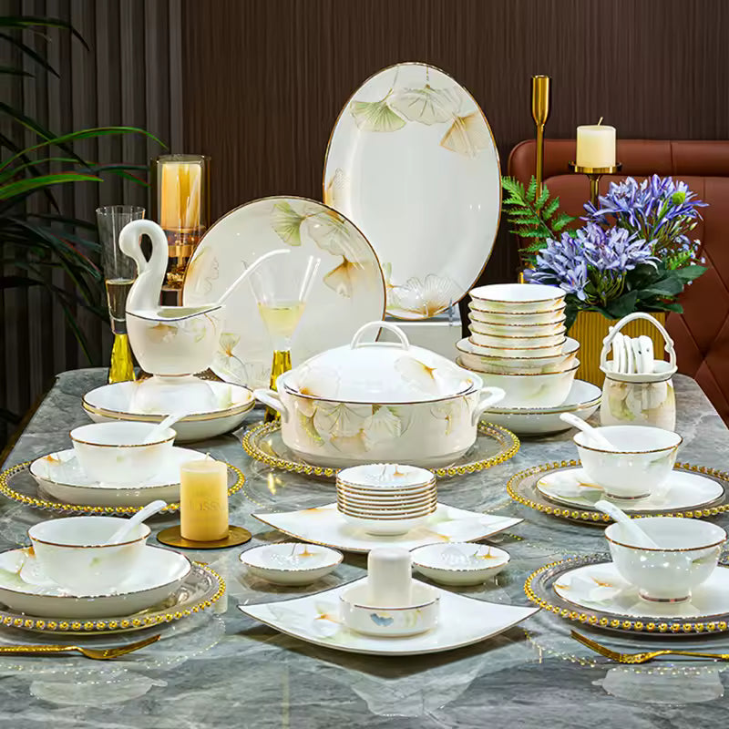 40-piece luxury New Bone China dinnerware set with gold-rimmed ginkgo leaf design, including a soup tureen, plates, bowls, and spoons.