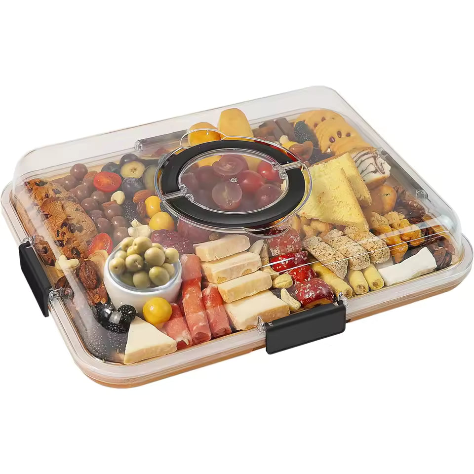 Large rectangular bamboo charcuterie board with 6 compartments filled with olives, cheese, and crackers, covered by a clear portable lid with a handle.