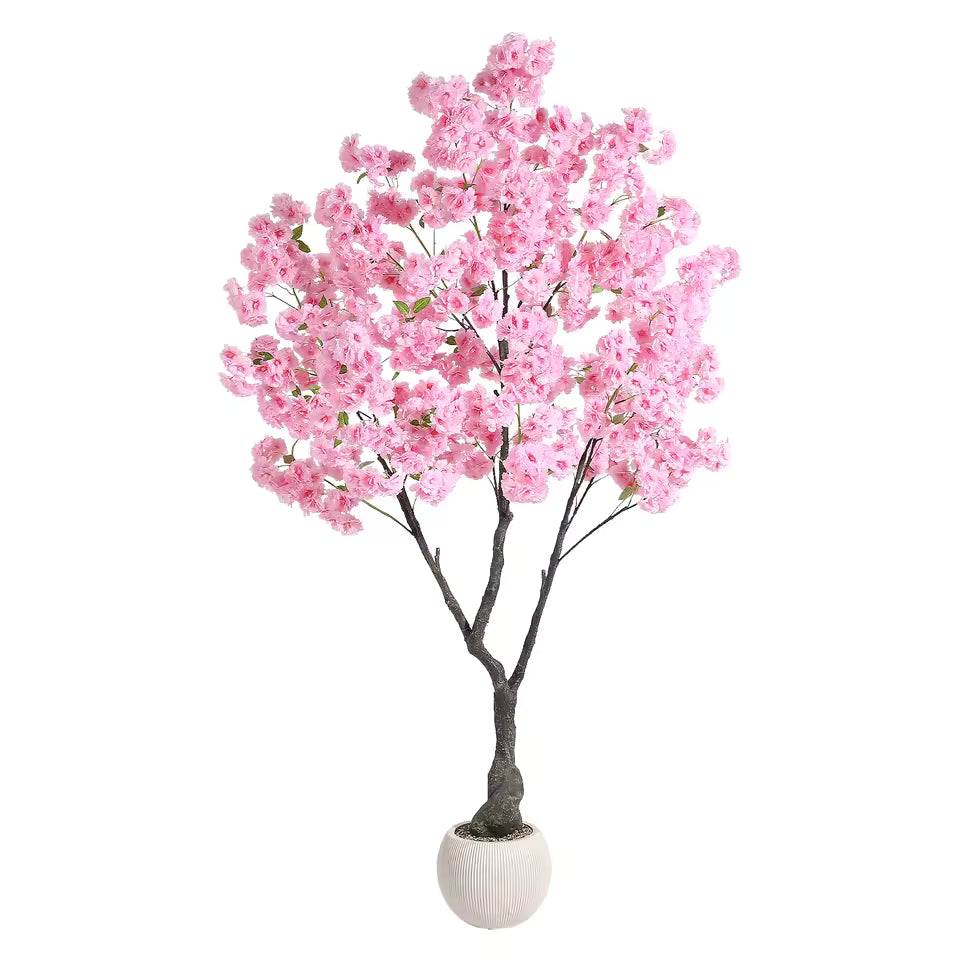 Artificial pink cherry blossom tree in a small round white pot, isolated on white background. Realistic silk flowers for interior decoration.
