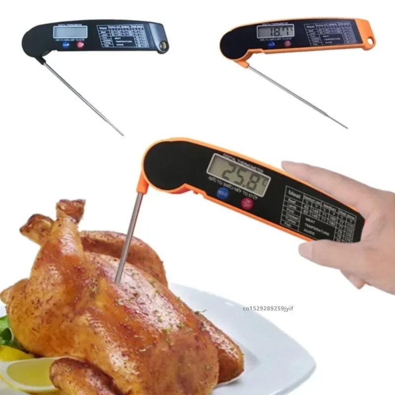 Digital instant-read meat thermometer with an orange foldable probe measuring the internal temperature of a roasted chicken.