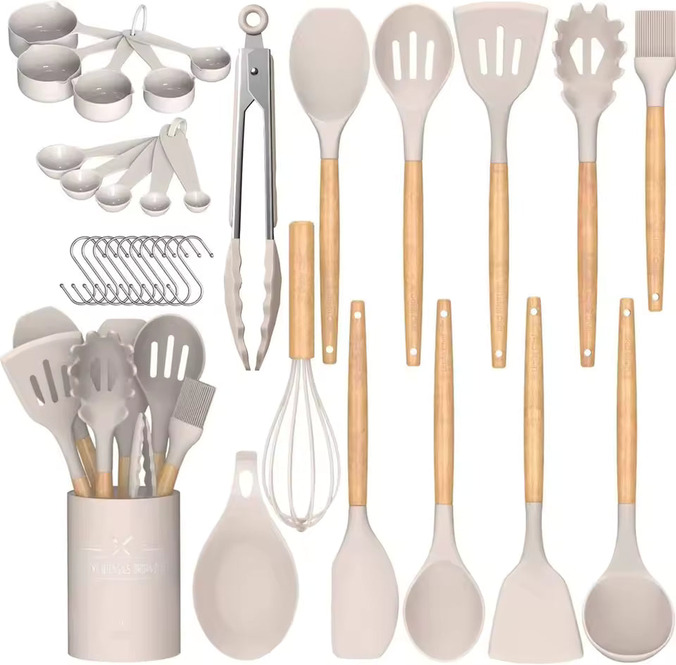 33-piece cream silicone kitchen utensil set featuring wooden handles, measuring cups, spoons, and a matching holder on a neutral background.