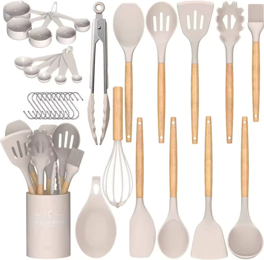 33-piece cream silicone kitchen utensil set featuring wooden handles, measuring cups, spoons, and a matching holder on a neutral background.