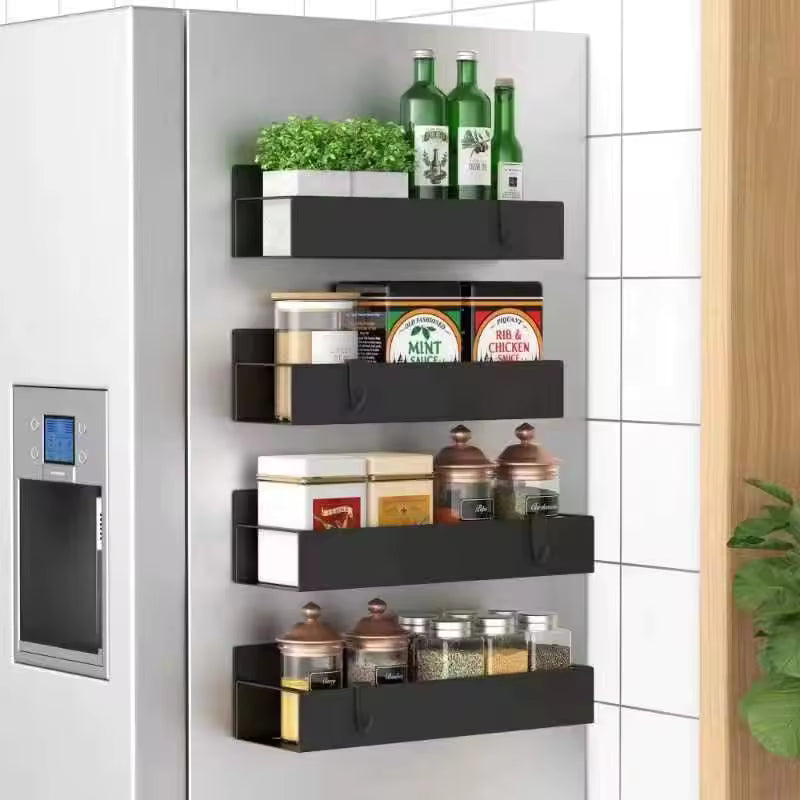 4-piece magnetic black matte spice racks attached to the side of a silver refrigerator, holding various jars and bottles.