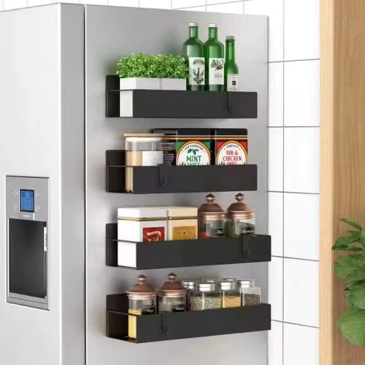 4-piece magnetic black matte spice racks attached to the side of a silver refrigerator, holding various jars and bottles.