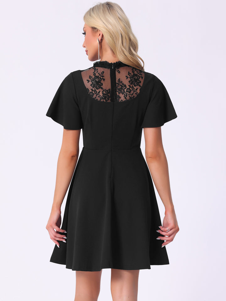 Black dress with lace detailing on a white background