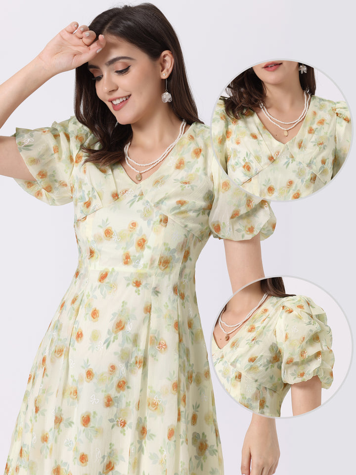 Woman wearing a light green floral dress with matching shorts on a white background