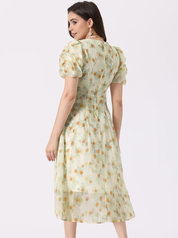 Woman wearing a light green floral dress on a white background