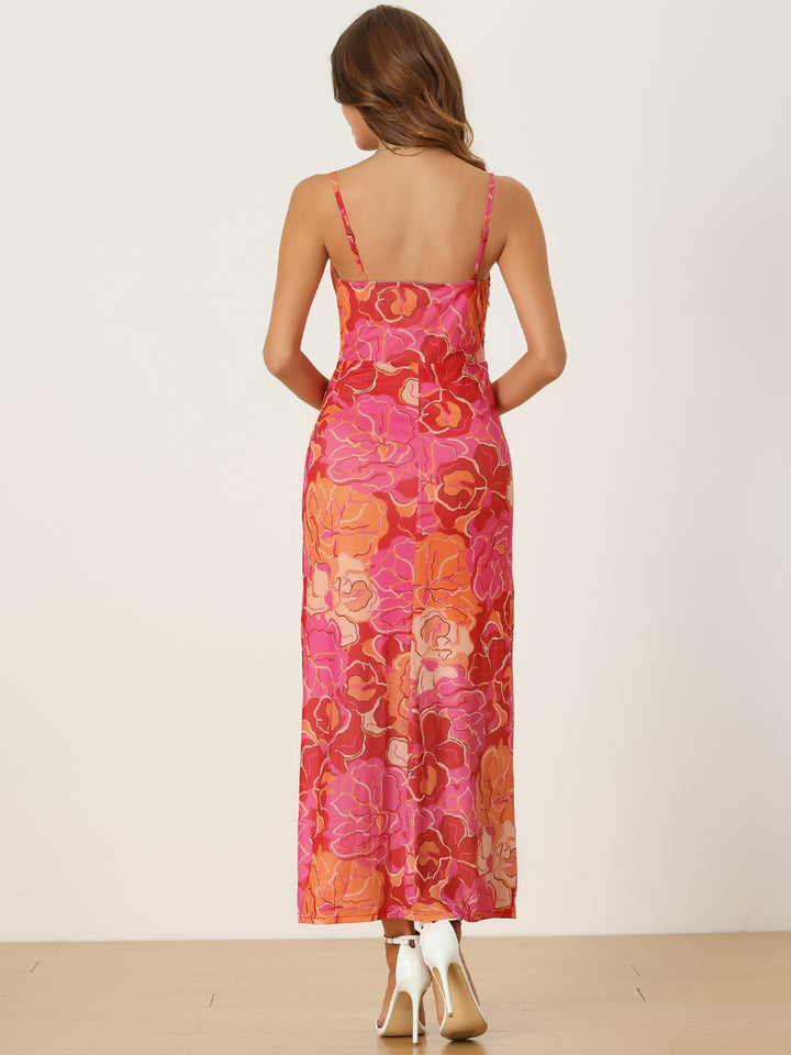 Woman wearing a floral pink and orange dress on a white background
