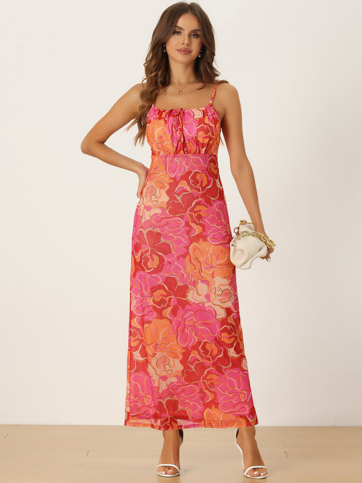 Woman wearing a floral dress with pink and orange pattern on a white background