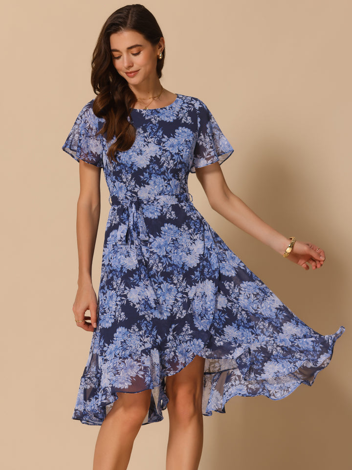 Woman wearing a blue floral dress against a beige background