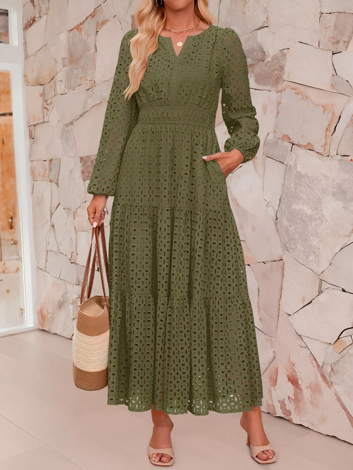 Woman wearing a green dress with a stone wall background