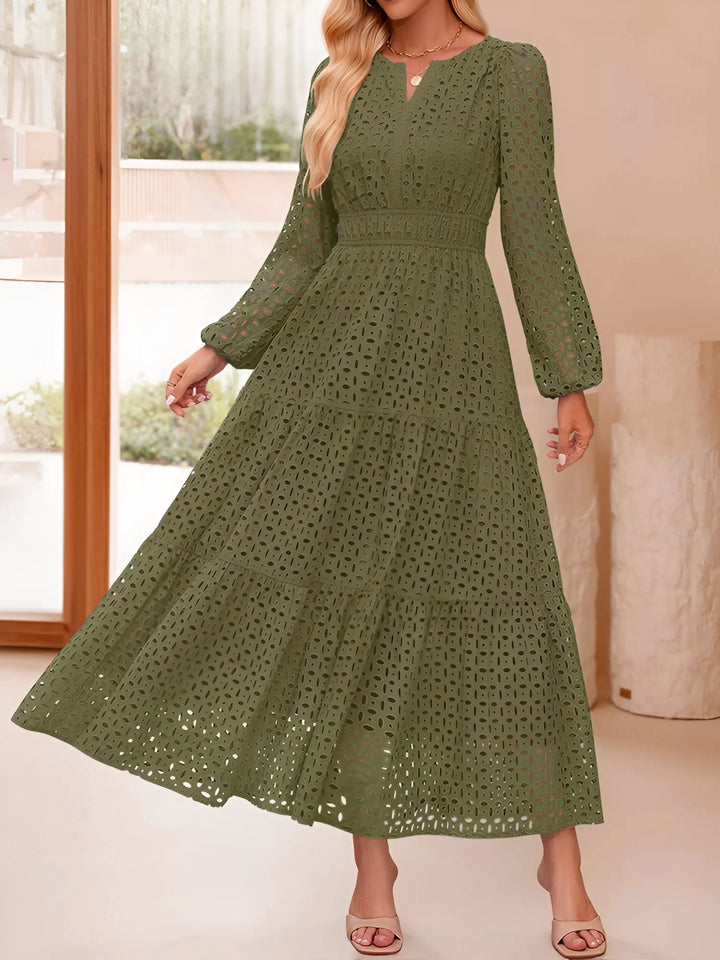 Green lace dress worn by a model indoors with a neutral background